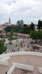 a group of people walking around a plaza at Casa da Dona Palmira in Fátima