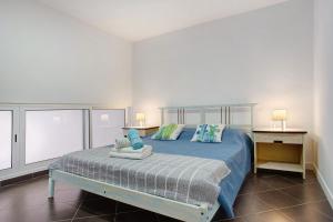 a bedroom with a bed with blue sheets and pillows at Funchal Boa Nova Apartment in Funchal