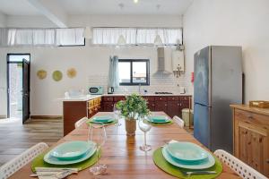 a kitchen with a wooden table with plates on it at Funchal Boa Nova Apartment in Funchal