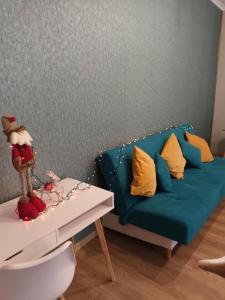 a living room with a blue couch and a table at IZZY'S HIDDEN APARTMENT in Braşov