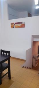 a room with a table and a white wall at DEPARTAMENTO Carlos paz próximo Costanera y autopista in Villa Carlos Paz