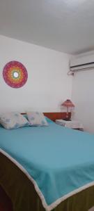 a bedroom with a bed with a blue light at DEPARTAMENTO Carlos paz próximo Costanera y autopista in Villa Carlos Paz