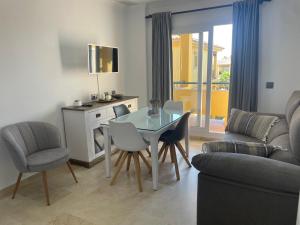 a living room with a glass table and chairs at Margaritas 27 in Chiclana de la Frontera