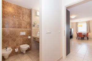 a bathroom with a toilet and a sink at Residence Marina Garbin Apartment in Portorož +31 photos
