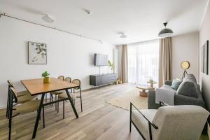a living room with a table and a couch at limehome Budapest Mosonyi u in Budapest
