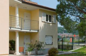 a white house with a balcony on the side of it at Residence Marina Garbin Apartment in Portorož