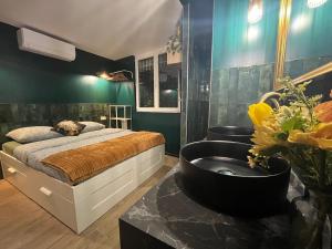 a bedroom with a bed and a bathroom with a sink at Le SPEAK EASY / JACUZZI ET SAUNA in Marseille