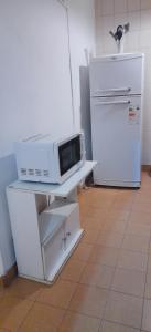 a microwave on a counter in a kitchen with a refrigerator at DEPARTAMENTO Carlos paz próximo Costanera y autopista in Villa Carlos Paz