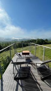 a wooden deck with two tables and a bench on it at Walden House Casarampi in Orsano +21 photos