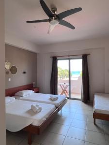 a bedroom with two beds and a ceiling fan at Michael’s Vacancies in Fánai