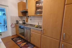 a kitchen with a sink and a stove top oven at Black Forest Schwarzwaldliebe Pool Sauna Tennis Tischtennis Wifi Netflix Natur in Obertal