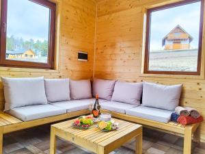 a living room with a couch and a table at Wierchy Beskidu in Dobra