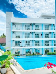 a large apartment building with a swimming pool at Bohol Dolphin Bay Resort in Panglao
