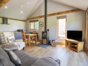 a living room with a couch and a flat screen tv at Ulverston House Annex in Harrogate