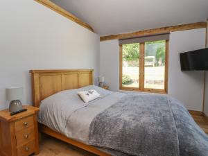 a bedroom with a large bed and a window at Ulverston House Annex in Harrogate