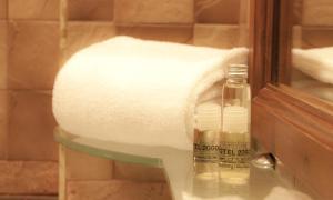 a roll of toilet paper and a bottle of soap at Hotel Motel 2000 in Trezzano sul Naviglio
