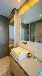 a bathroom with a white sink and a shower at Sunrise Beachfront Villas - Villa 1 in Paralimni