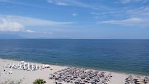 an aerial view of a beach with chairs and umbrellas at Villa Un bel posto Sea View in Nea Vrasna