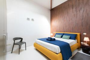 a bedroom with a large bed and a chair at Girolamo Loft by Welchome in Venice