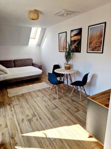 a living room with a couch and a table and chairs at Apartament Amelia1 in Świnoujście