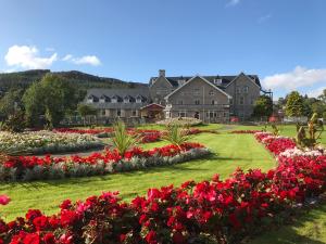 a row of flowers in front of a large building at Duke Of Gordon Hotel in Kingussie