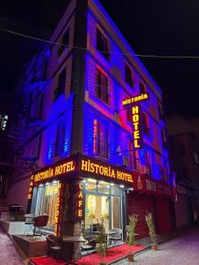 a building with a blue lit up sign on it at historia hotel in Istanbul