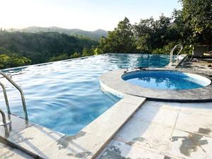 a large swimming pool with a plungescribedscribed at The Sky Imperial Pavoreal Jungle Resort in Kumbhalgarh