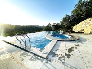 a swimming pool with a fountain on a patio at The Sky Imperial Pavoreal Jungle Resort in Kumbhalgarh