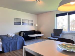 a living room with a couch and a table at One Bedroom Apartment In Rdovre, Trnvej 33a, in Rødovre