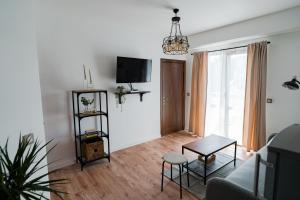 a living room with a couch and a tv at Le petit escape in Varna City