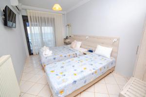 Postel nebo postele na pokoji v ubytování Hotel Zefyros