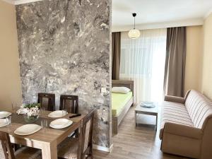 a living room with a table and a couch at Apartmani Sunce in Bar
