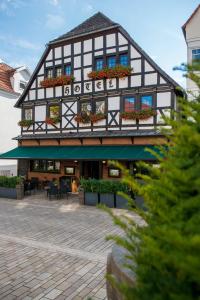 a black and white building with lots of windows at Hotel zum Braunen Hirschen in Bad Driburg