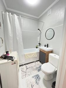 a bathroom with a toilet and a sink and a tub at ЖК Шугыла-Панорамный вид на горы! in Shugyla