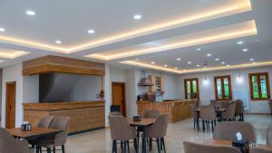 a banquet hall with tables and chairs and a large screen at SultanMurat-Otel-Görnek Tabiat Parkı in Trabzon