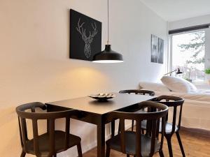 a dining room with a black table and chairs at Studio Apartment In Rdovre, Trnvej 49d, 3 in Rødovre