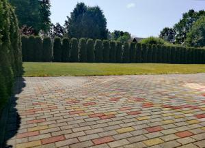 a brick driveway with a fence in the background at Exclusive Mansion Jurmala in Jūrmala