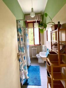 a bathroom with a shower and a toilet and a sink at Goga&Romeo in Pesaro