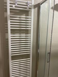 a white closet with a glass door and a mirror at Cucchiari Suite 7A in Modena