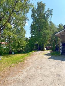 a dirt road next to a house with trees at Big Duplex, 15min to Turku or Naantali in Turku