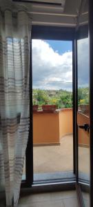 a sliding glass door with a view of a balcony at Petranova Affittacamere B&b in Agropoli