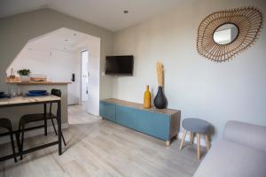 a kitchen and living room with a table and chairs at Modern apartement in the city center. in Poissy