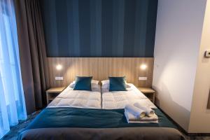 Łóżko lub łóżka w pokoju w obiekcie Hotel Zatoka