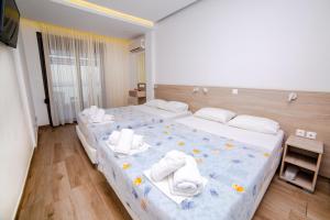 Postel nebo postele na pokoji v ubytování Hotel Zefyros