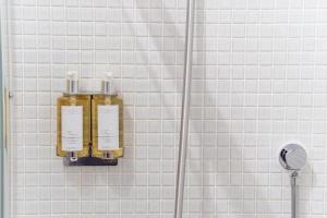 a bottle of soap on a wall in a bathroom at Trewhiddle Retreat V11 by Together Travel - Luxury 4-Bedroom Villa in St Austell