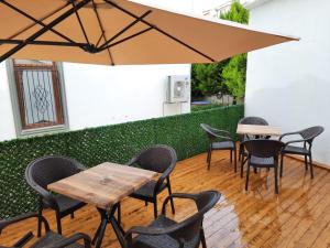 a patio with tables and chairs and an umbrella at JK BUSINESS HOTEL in Denizli