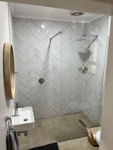 a bathroom with a shower and a sink at Clearwater Farm Venue in Port Edward