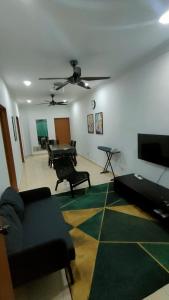 a living room with a couch and a table at Deena's Cottage Kulim Hitech Hospital Kulim, Three-bedrooms Single Storey Terrace House in Kulim