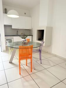 a kitchen with a glass table and two chairs at Casita1906 in Rocchetta a Volturno