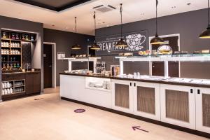 a bar in a restaurant with a counter at Premier Inn Stuttgart City Centre in Stuttgart +16 photos